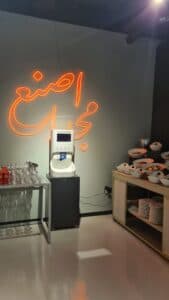 Smixin handwashing station beneath neon signage in a hospitality venue