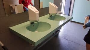 Two Smixin touch-free handwashing systems in a public washroom